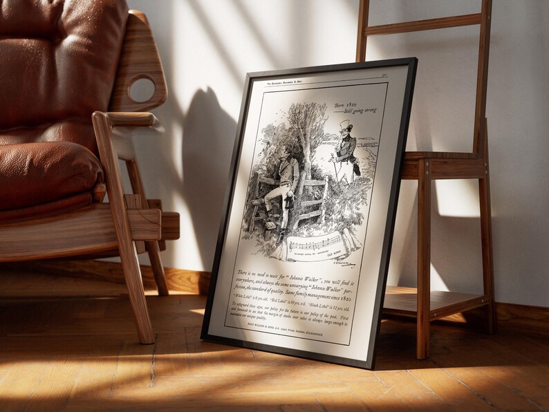 May include: Framed black and white print of a vintage advertisement. The illustration depicts two men in a pastoral setting, with text at the top and bottom. The print is leaning against a wooden easel and a leather chair.