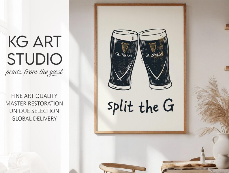 May include: A framed print featuring two Guinness pint glasses with the text "split the G". The print is in black and white with a cream-colored background. The print is from KG Art Studio.