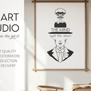 May include: Black and white art print featuring a stylized illustration of a man with a mushroom cloud above his head. The text reads "THE MIND split the atom." The print is framed in a wooden frame.
