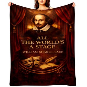 May include: A plush throw blanket featuring a portrait of William Shakespeare with the text "All the World's a Stage." The design includes theater masks, a quill, and an open book, set against a backdrop of red curtains. The blanket is a warm, inviting home decor item.