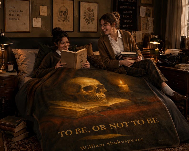 May include: A dark-toned throw blanket featuring a large human skull resting on an open book, a lit candle, and the text "TO BE, OR NOT TO BE" followed by "William Shakespeare" in gold lettering, displayed over a bed in a dimly lit room.