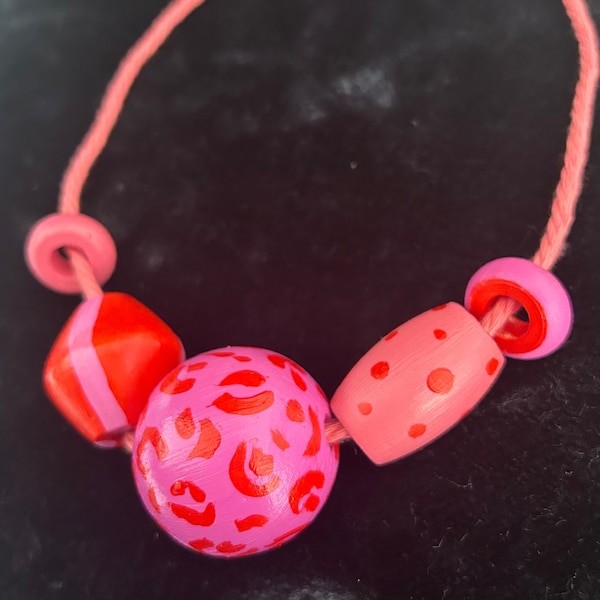 chunky, bold statement necklace. Hand painted bright, colour clash wooden beads. leopard print, polka dot hot pink, coral. Prue leith style