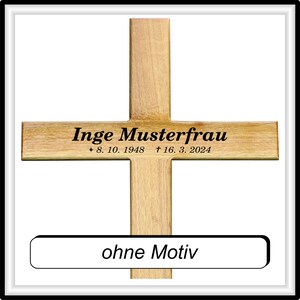 May include: A wooden cross with the inscription "Inge Musterfrau * 8. 10. 1948 &dagger; 16. 3. 2024" and the words "ohne Motiv" on a separate plaque.