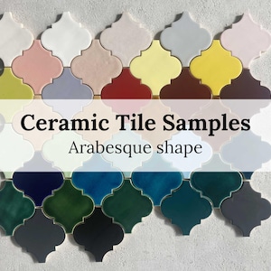 Może przedstawiać: Próbki płytek ceramicznych w różnych kolorach i wykończeniach, ułożone w kształt arabeski. Płytki mają ten sam rozmiar i błyszczące wykończenie.