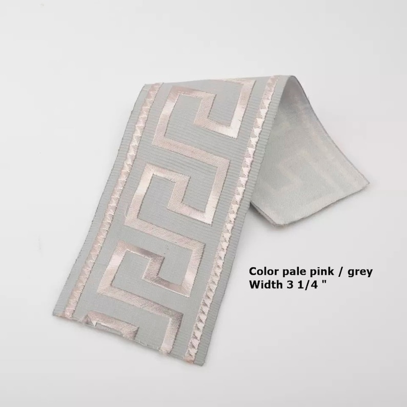 May include: Pale pink and grey trim with a Greek key design. The trim is 3 1/4 inches wide.
