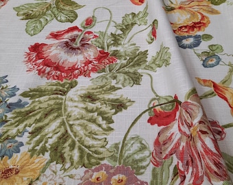 May include: A white fabric with a floral pattern featuring red, yellow, and blue flowers. The fabric has a textured linen-like appearance.