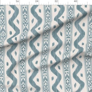 May include: A fabric featuring a repeating pattern of vertical teal zigzag lines and central columns with small floral motifs on a light cream background. The design has a textured, hand-drawn appearance with soft edges and consistent vertical alignment.