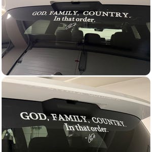 May include: White vinyl decal applied to a car's rear window, displaying the text "GOD, FAMILY, COUNTRY. In that order." in a bold, sans-serif font. A signature is below the text. The car is white.