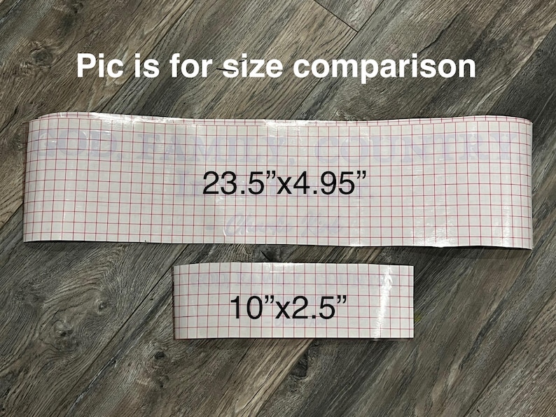 May include: Two pieces of material with a red grid pattern, one measuring 23.5" x 4.95" and the other 10" x 2.5". The text "Pic is for size comparison" is at the top. The items are on a wood-grain surface.