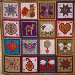 May include: A colorful needlepoint wall hanging with a variety of designs, including a rooster, a camel, a butterfly, a bee, a dragonfly, a flower, a heart, a star, and a fish. The designs are all stitched in different colors and patterns.
