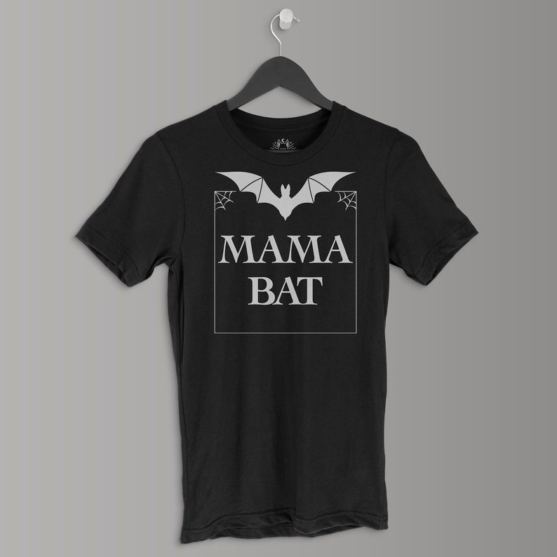 May include: Black t-shirt with a white bat graphic and the text "MAMA BAT" in a white box.
