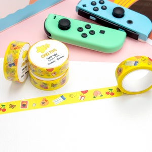 May include: Yellow washi tape rolls with a variety of cute designs, including cherries, butterflies, and a money bag. The tape is labelled "Chibi Pins Washi Tape 15mm x 10m".