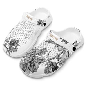 May include: White floral print clogs with a black and white floral design and a gold "LOLUBEE KEWO" label on the strap.