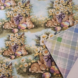 May include: Easter-themed fabric featuring a repeating pattern of brown bunnies, baskets of daisies, and colorful Easter eggs. A plaid fabric with blue, green, and pink hues is partially visible in the corner. The overall design has a vintage, springtime feel.