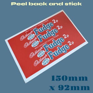 May include: A red and white rectangular sticker with the text "Cadbury's Fudge 2p" repeated four times. The sticker is 150mm by 92mm.