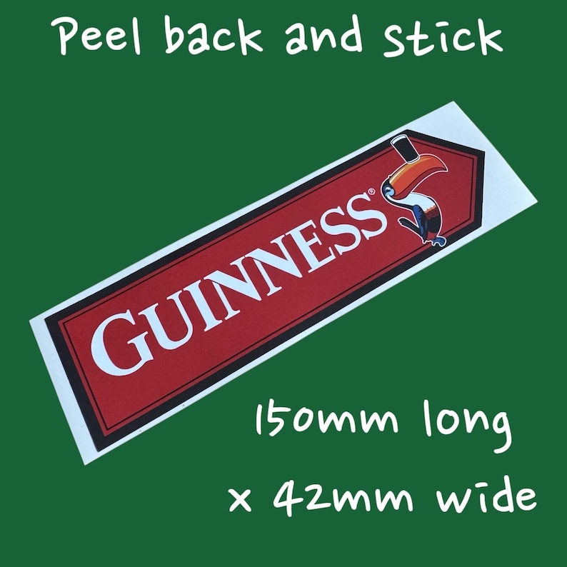 May include: A rectangular sticker with the Guinness logo in white on a red background, featuring a toucan. The sticker is 150mm long and 42mm wide, with the text "Peel back and stick".