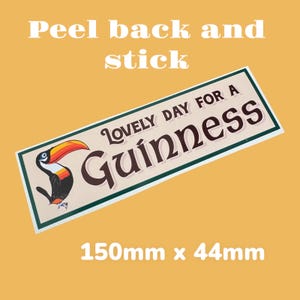 May include: A peel-and-stick sticker featuring a toucan with a green, white, and brown background. The sticker reads "Lovely Day For A Guinness" and measures 5.9 inches by 1.7 inches.