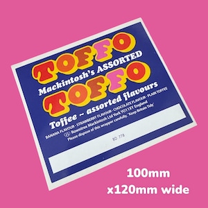 Peut inclure: Un emballage bleu et blanc pour une boîte de Toffee Mackintosh. L'emballage présente le texte "Toffee - assorted flavours" et liste les saveurs : Banane, Fraise, Chocolat et Toffee nature. L'emballage comprend également le texte "Keep Britain Tidy" et l'adresse de l'entreprise : Rowntree Mackintosh Ltd York YO11XY England. L'emballage mesure 10 cm sur 12 cm.