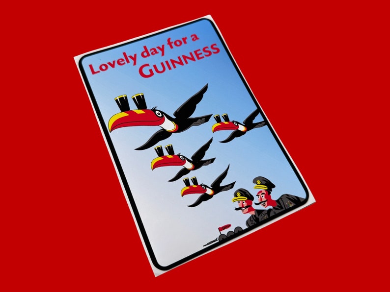 May include: A blue and white sign with the text "Lovely day for a GUINNESS" and a cartoon illustration of toucans carrying glasses of Guinness.