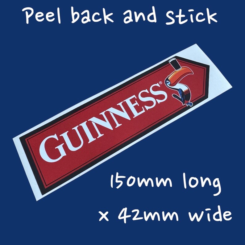 May include: A rectangular sticker with the Guinness logo in white on a red background, featuring a toucan illustration. The sticker is 150mm long and 42mm wide, with the text "Peel back and stick".