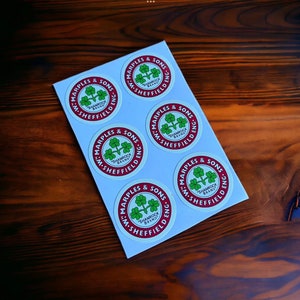 Op de afbeelding: Vijf witte ronde stickers met rode randen en groene klaverbladlogo's. De stickers zeggen "Wm. Marples & Sons" "Shamrock Brand" en "Sheffield Eng."