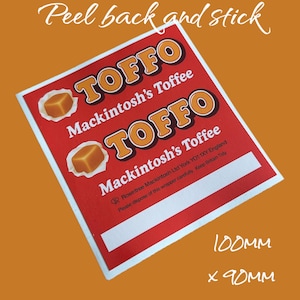 May include: A red and white sticker with the text "TOFFO Mackintosh's Toffee" and a picture of a caramel candy. The sticker is 4 inches by 3.5 inches.