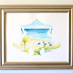 May include: A watercolor painting of a beach scene with a palm tree, blue water, and white sand. The painting is framed in a light wood frame.