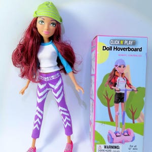 May include: A doll with red hair, wearing a white and blue shirt, purple pants with white chevron designs, and a green and yellow beanie. The doll is standing next to a box that says "CLICK N' PLAY Doll Hoverboard".