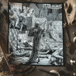 May include: Black and white patch with a detailed illustration of a skeletal figure playing a violin amidst a scene of death and despair. The artwork depicts figures in medieval attire, with gothic elements.