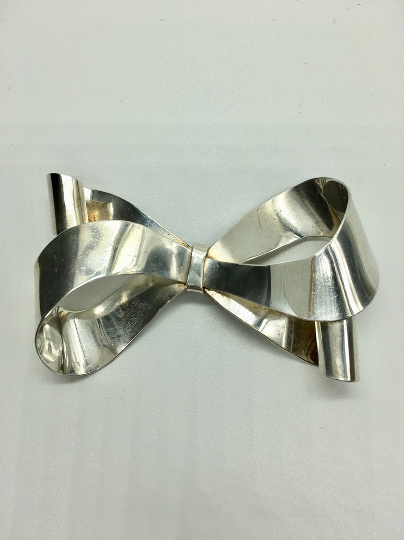 Large sterling silver bow brooch with curling ribbon ends