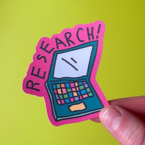 May include: A sticker featuring a teal laptop with a colorful keyboard and a white screen with two diagonal lines. The sticker has a pink border with the word "RESEARCH!" in pink letters.