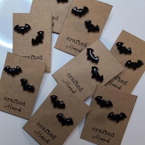 May include: A white ceramic mug with a black handle and the text "But First, Coffee" in a handwritten style. The mug is on a white surface. The mug is 4 inches tall.