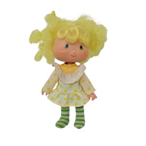 Muñeca vintage de tarta de fresa, limón y merengue con lazo amarillo, años 80