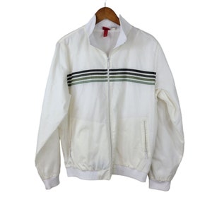 May include: A white zippered jacket with a striped pattern in green, black, and white.