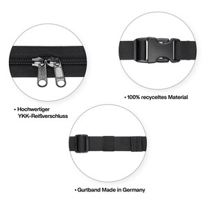 May include: Close-up of a black belt with a silver zipper and a black plastic buckle. The text "Hochwertiger YKK-Rei&szlig;verschluss" is visible. The belt is made of 100% recycled material and the strap is made in Germany.