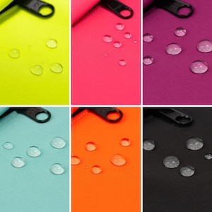 May include: Six fabric swatches in different colors, each with a zipper pull and water droplets on the surface. The colors are neon yellow, pink, purple, turquoise, orange, and black.