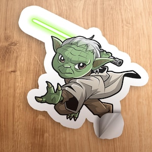 May include: A green cartoon Yoda character with a lightsaber, holding a lightsaber in his right hand, with a white background.