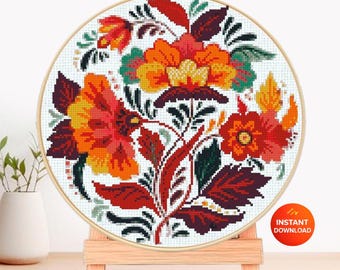May include: A cross-stitch pattern in a wooden hoop, featuring a floral design in shades of red, orange, and yellow. The text "CROSS STITCH PATTERN" is at the top, with "PDF PATTERN" and "INSTANT DOWNLOAD" labels.