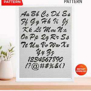 May include: A cross stitch pattern featuring the alphabet, numbers, and symbols in a black, cursive font. The design is displayed on a white background within a white frame. The words "Cross Stitch Pattern" and "PDF Pattern" are also visible.