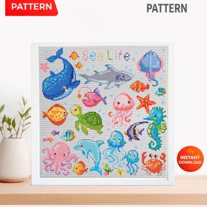 May include: A framed cross-stitch pattern featuring various sea creatures, including a whale, shark, and octopus. The design includes the text "Sea Life" and is surrounded by a white frame. The image also includes the text "PDF Pattern" and "Instant Download".