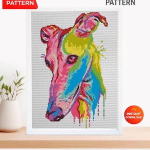 May include: A cross stitch pattern featuring a colorful, pixelated portrait of a greyhound dog. The design uses vibrant shades of pink, yellow, blue, and green to depict the animal's head against a white grid background. Text reads PDF PATTERN, CROSS STITCH PATTERN, and INSTANT DOWNLOAD.
