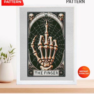 Puede incluir: Patrón de punto de cruz enmarcado que presenta una mano esquelética haciendo la señal del dedo medio. El diseño incluye un fondo de telaraña, calaveras y el texto "THE FINGER". La imagen está etiquetada como "PDF PATTERN" y "INSTANT DOWNLOAD".