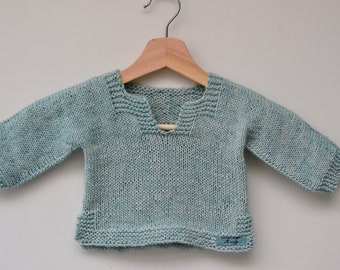 Handmade soft blue knitted cotton baby sweater.