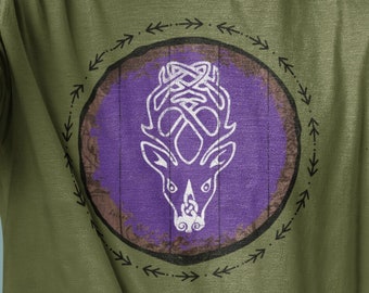 May include: A green t-shirt with a purple and white graphic of a deer head inside a circle with arrows around it.