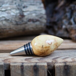 A premium bottle stopper made from a beautiful piece of spalted Chestnut and Stainless steel. Wooden bottle stopper.