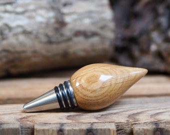 A bottle stopper made from a beautiful piece of Oak and Stainless steel. Wooden bottle stopper.