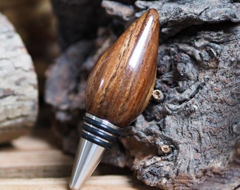 A premium bottle stopper made from a beautiful piece of Tanga wood and Stainless steel. Wooden bottle stopper.