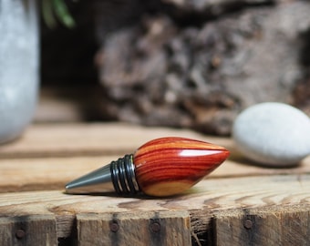 A premium bottle stopper made from a beautiful piece of tulip wood and Stainless steel. Wooden bottle stopper.