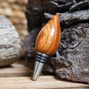 A premium bottle stopper made from a beautiful piece of Xylia wood and Stainless steel. Wooden bottle stopper.