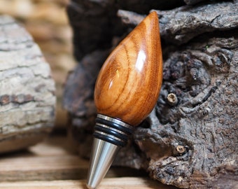 A premium bottle stopper made from a beautiful piece of Xylia wood and Stainless steel. Wooden bottle stopper.